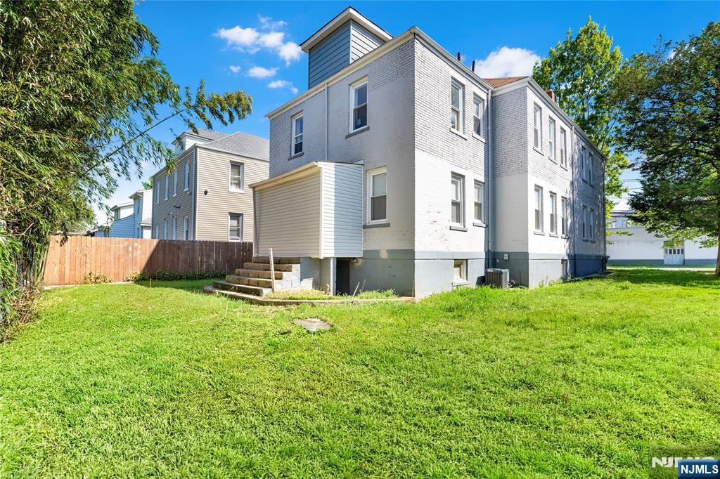 183 Bergen Turnpike Ridgefield Park, NJ 07660 - Photo 3 of 18 a backyard of a house with table and chairs