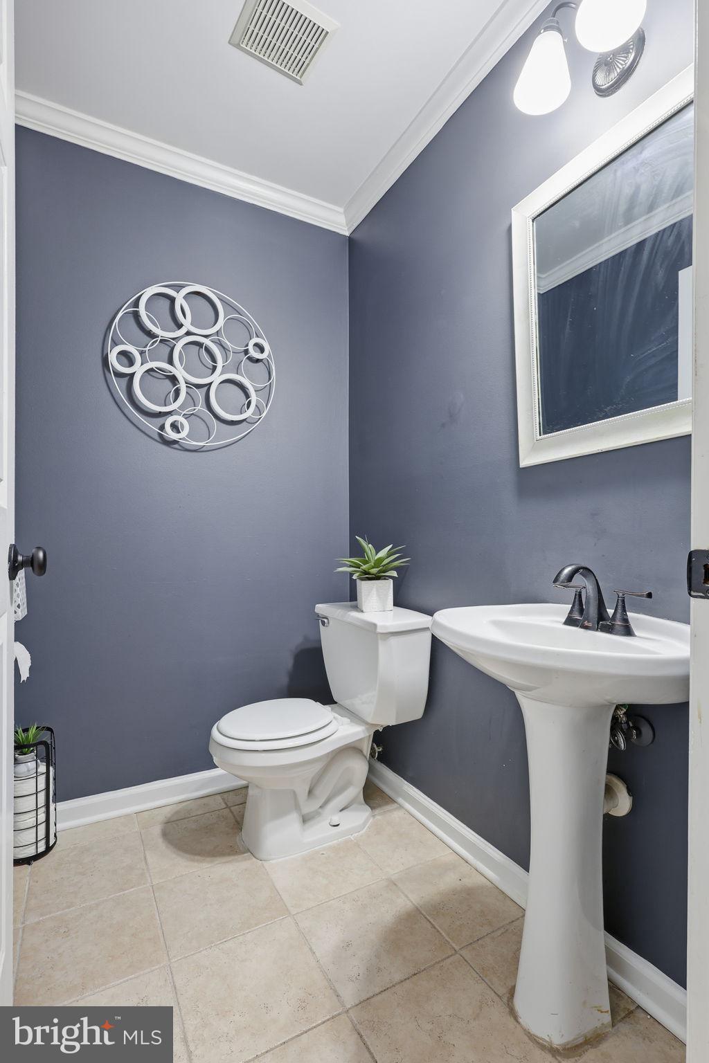 9332 Wax Myrtle Way Manassas, VA 20110 - Photo 13 of 40 a bathroom with a toilet sink and mirror