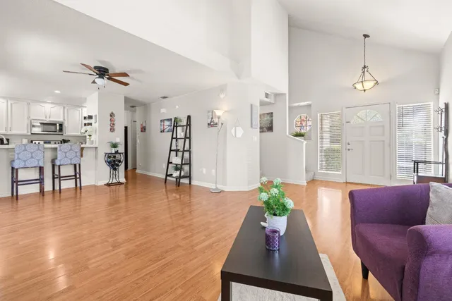 a living room with furniture and wooden floor