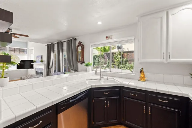 a kitchen with stainless steel appliances a sink stove and cabinets