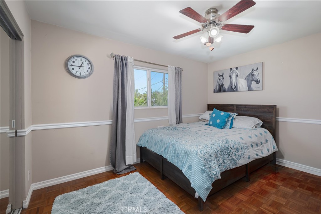 2203 Homewood Avenue Simi Valley, CA 93063 - Photo 24 of 37 a bedroom with a bed and a chandelier