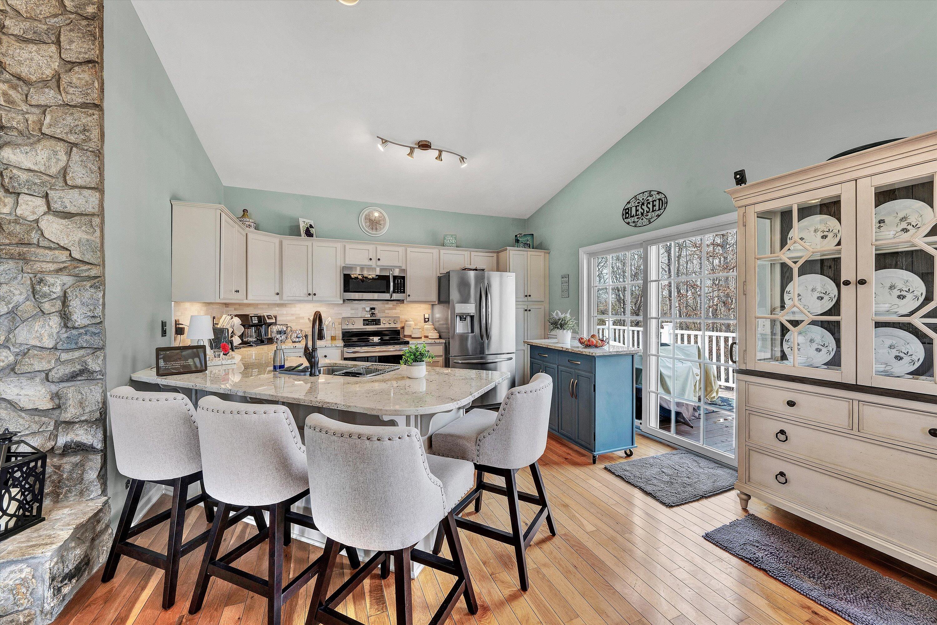1615 Morewood Road Hardy, VA 24101 - Photo 12 of 46 a kitchen with stainless steel appliances kitchen island granite countertop a dining table chairs and white cabinets