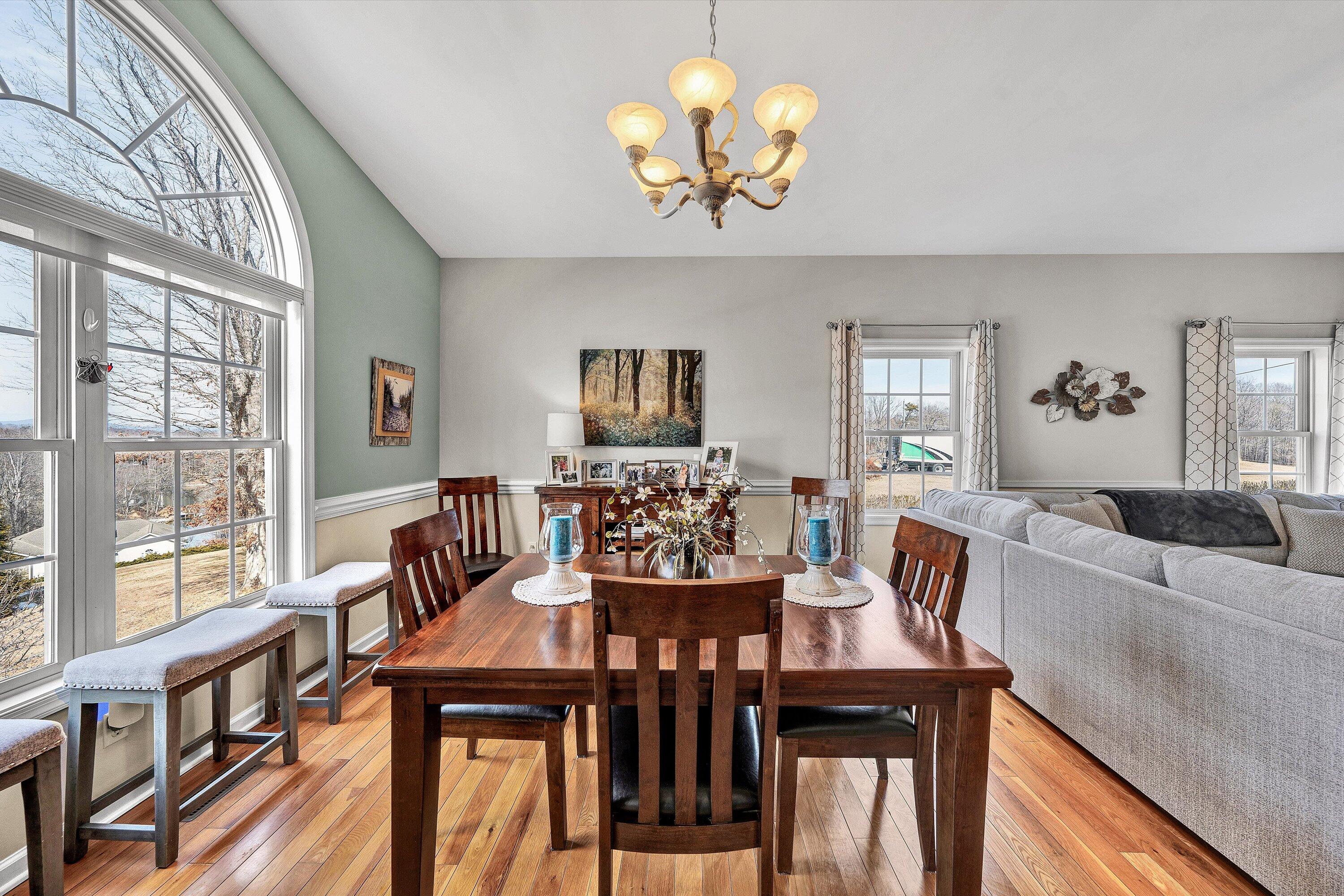 1615 Morewood Road Hardy, VA 24101 - Photo 15 of 46 a view of a dining room with furniture a chandelier and large windows