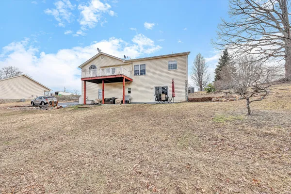 a view of a house with a patio and a yard