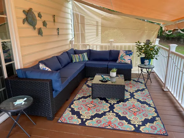 a view of a house with backyard and sitting area