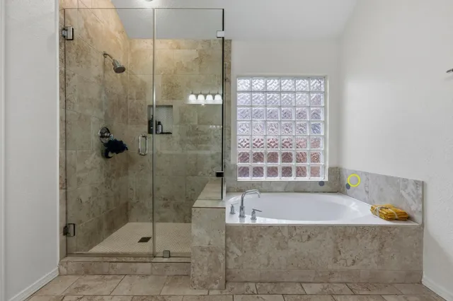 a bathroom with a bath tub and shower