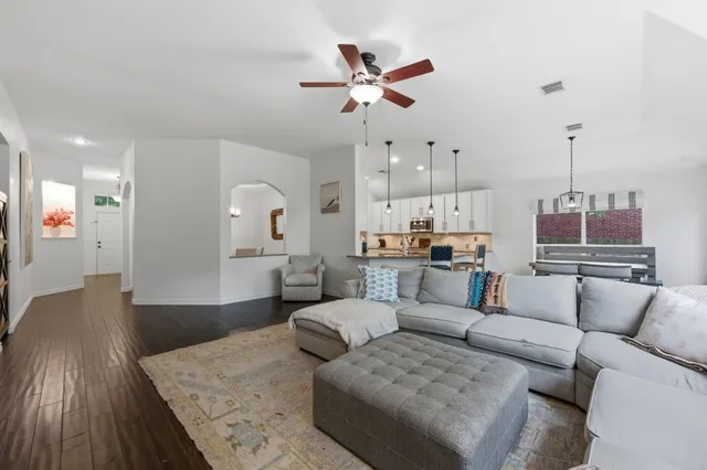 a living room with furniture and kitchen view