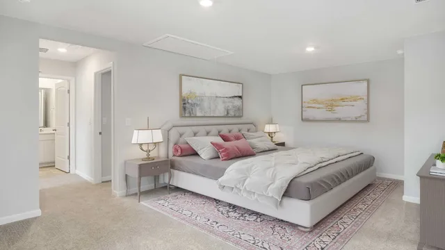 a bedroom with a bed and a painting on the wall