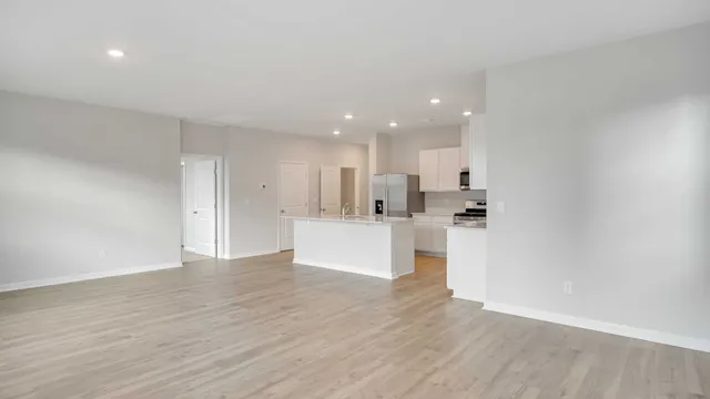 a view of kitchen with kitchen island cabinets and wooden floor