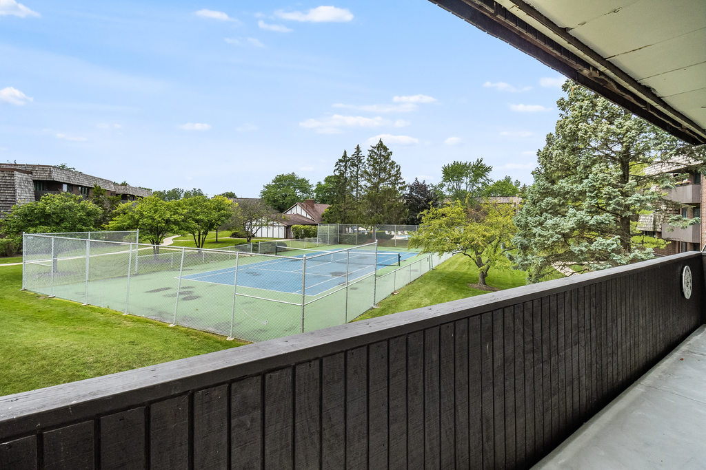 516 Timber Ridge Drive, Unit 206B Carol Stream, IL 60188 - Photo 3 of 20 a view of outdoor space with swimming pool and lake view