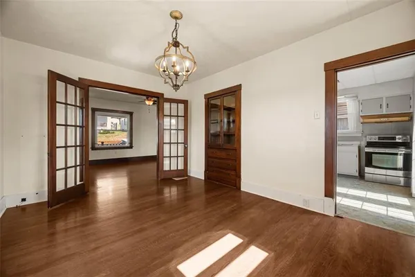 a view of a livingroom with a furniture wooden floor and windows