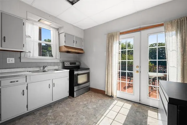a kitchen with granite countertop a stove a sink and a granite counter tops