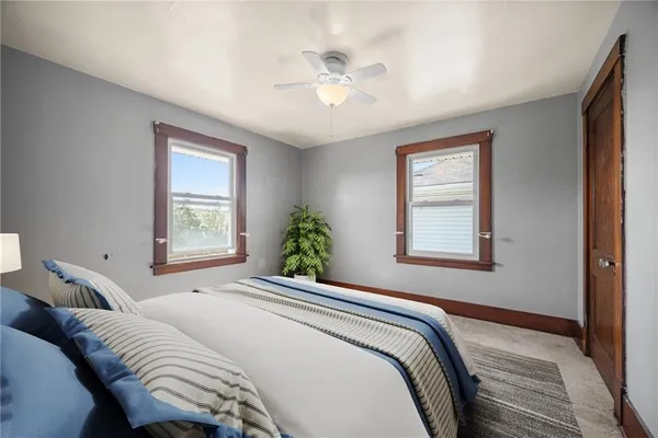 a bedroom with a large bed and a window