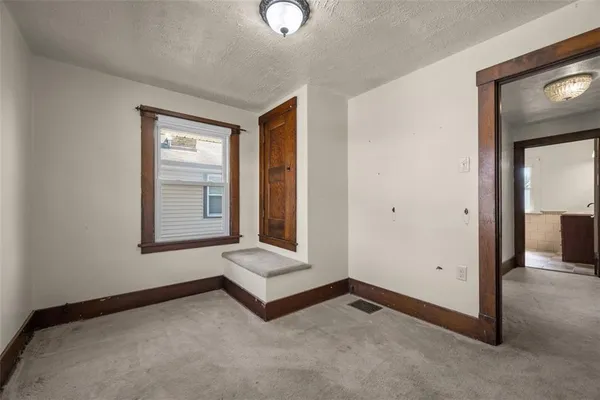 an empty room with windows and closet