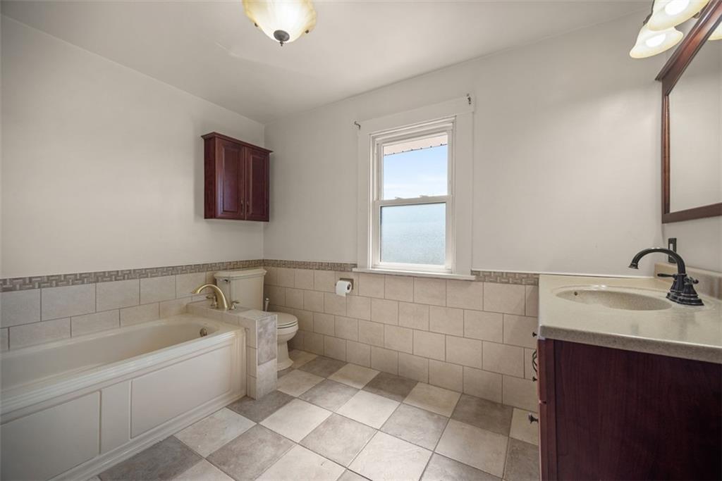 745 6th Street Beaver, PA 15009 - Photo 22 of 36 a bathroom with a bathtub sink vanity and mirror
