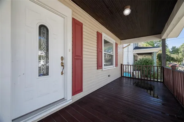 a view of a porch with wooden floor and outdoor space