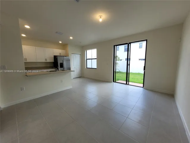 an empty room with windows and entrance