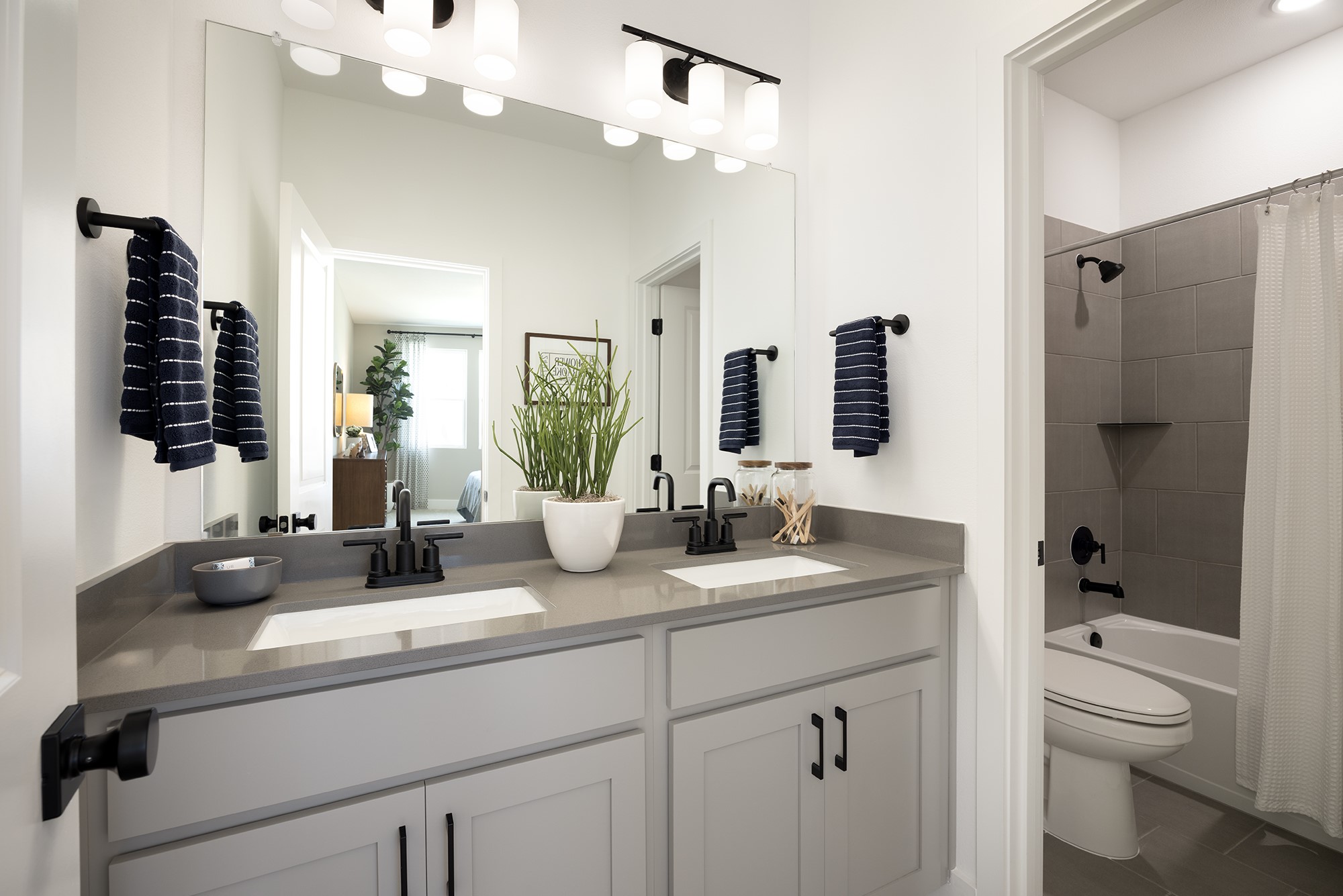 270 Romans Road Kyle, TX 78640 - Photo 10 of 23 a bathroom with a double vanity sink a toilet and a mirror