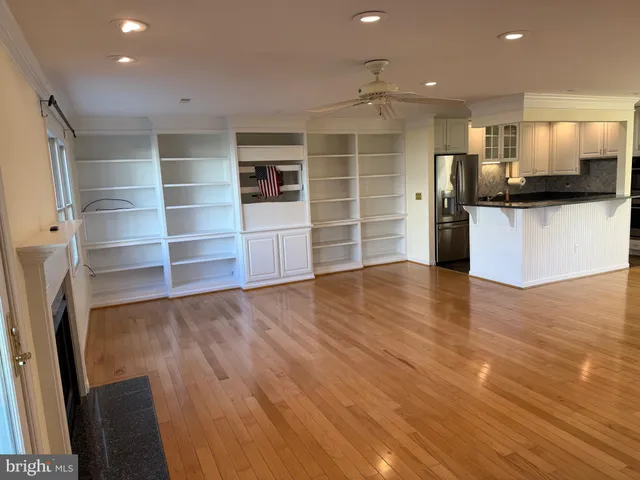 a view of a kitchen with furniture and wooden floor