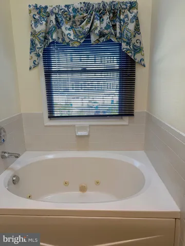 a bathroom with a bathtub and shower