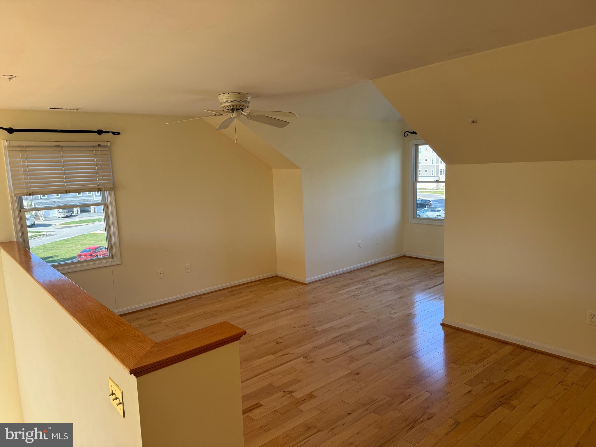 807 Auckland Way Chester, MD 21619 - Photo 29 of 42 an empty room with wooden floor and windows