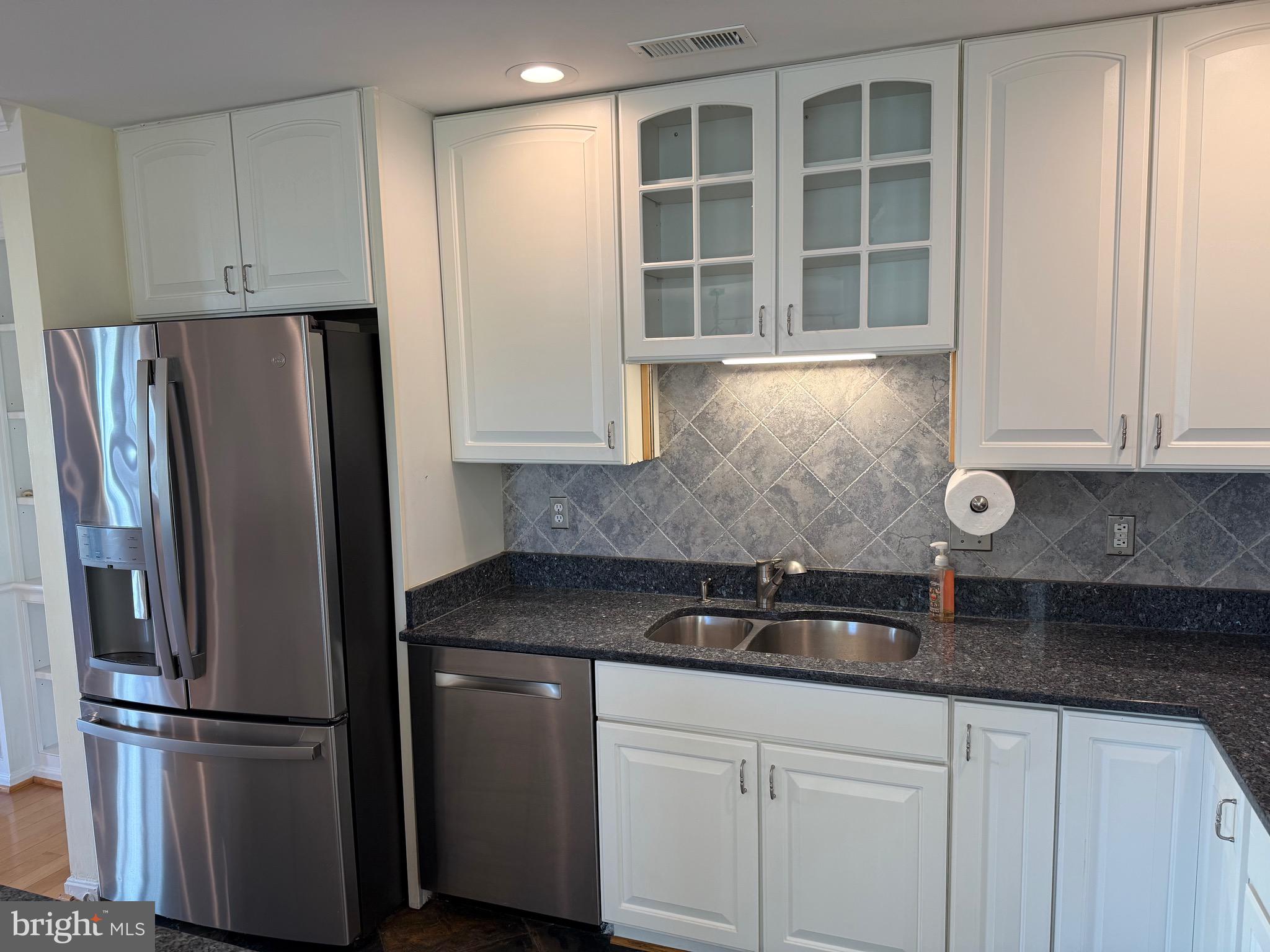807 Auckland Way Chester, MD 21619 - Photo 4 of 42 a kitchen with stainless steel appliances granite countertop a refrigerator and a sink