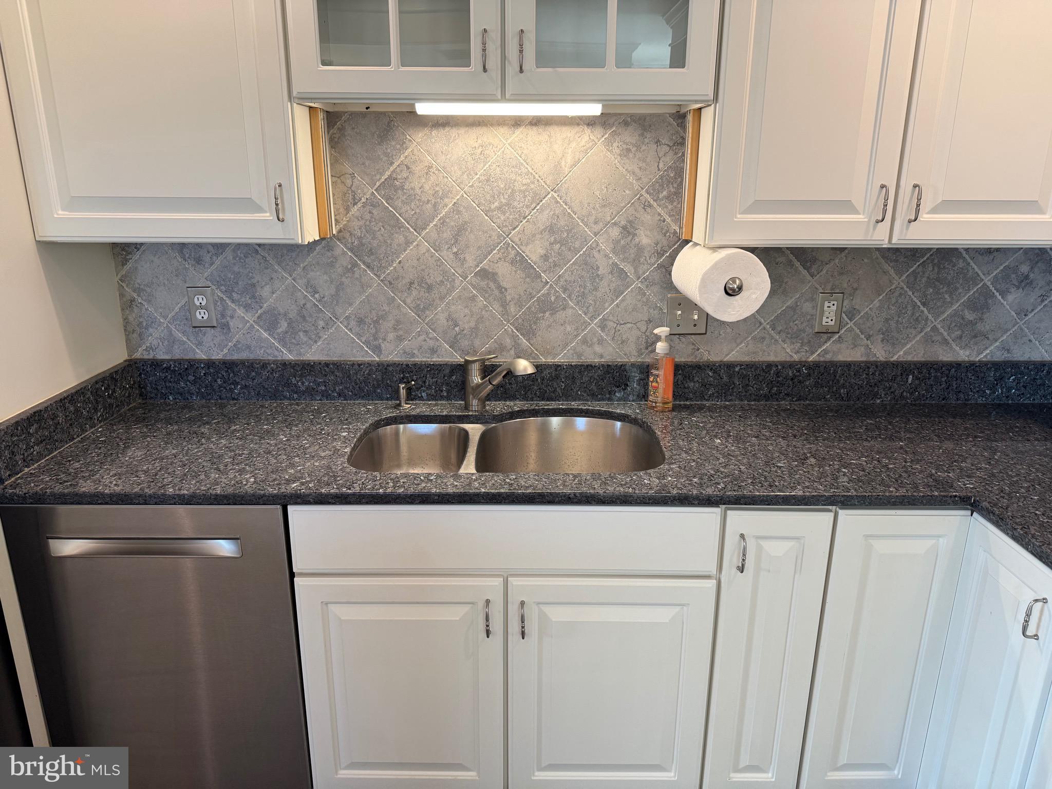 807 Auckland Way Chester, MD 21619 - Photo 8 of 42 a kitchen with granite countertop a sink and cabinets