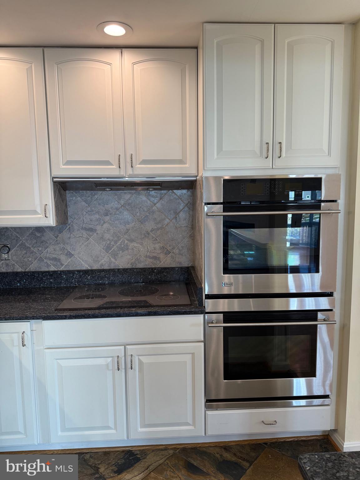 807 Auckland Way Chester, MD 21619 - Photo 9 of 42 a kitchen with white cabinets and appliances