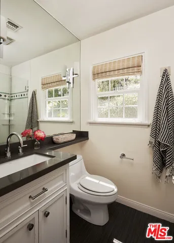 a bathroom with a toilet a sink and a window
