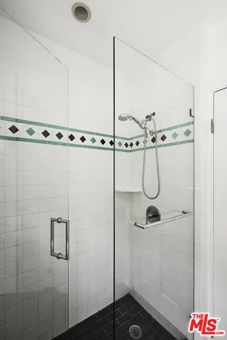 a bathroom with a shower and a sink