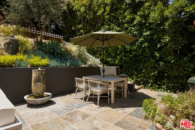 a patio with a table and chairs