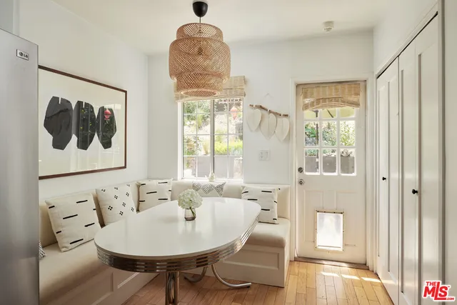 a view of a dining room with furniture window and wooden floor