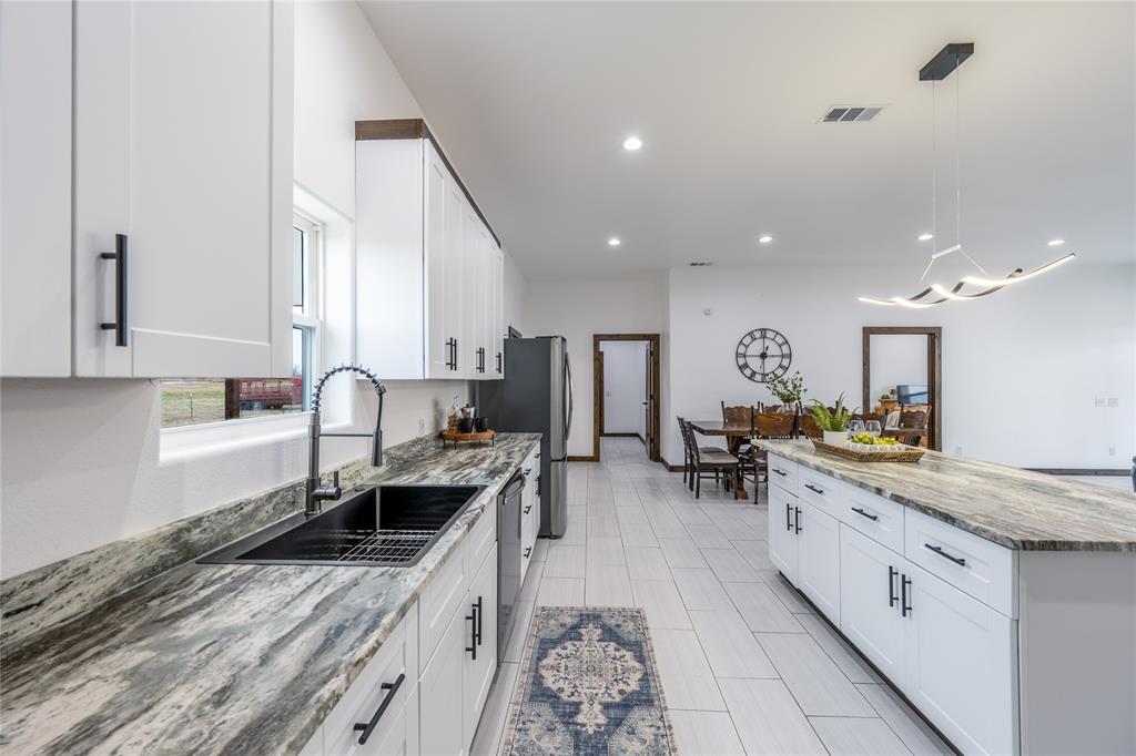 1706 County Road Sumner, TX 75486 - Photo 13 of 28 a large kitchen with stainless steel appliances a lot of counter space and a sink