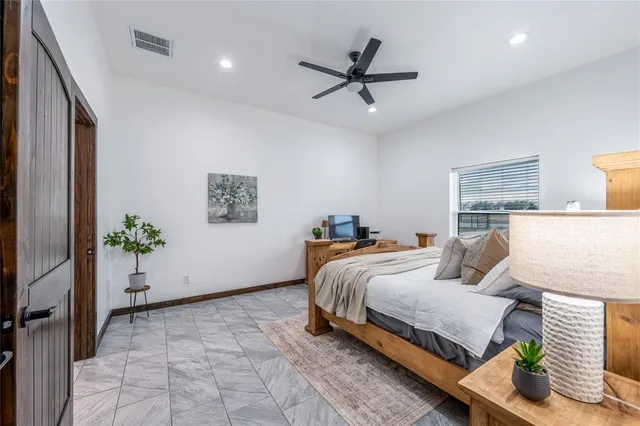 a bedroom with a bed and a potted plant