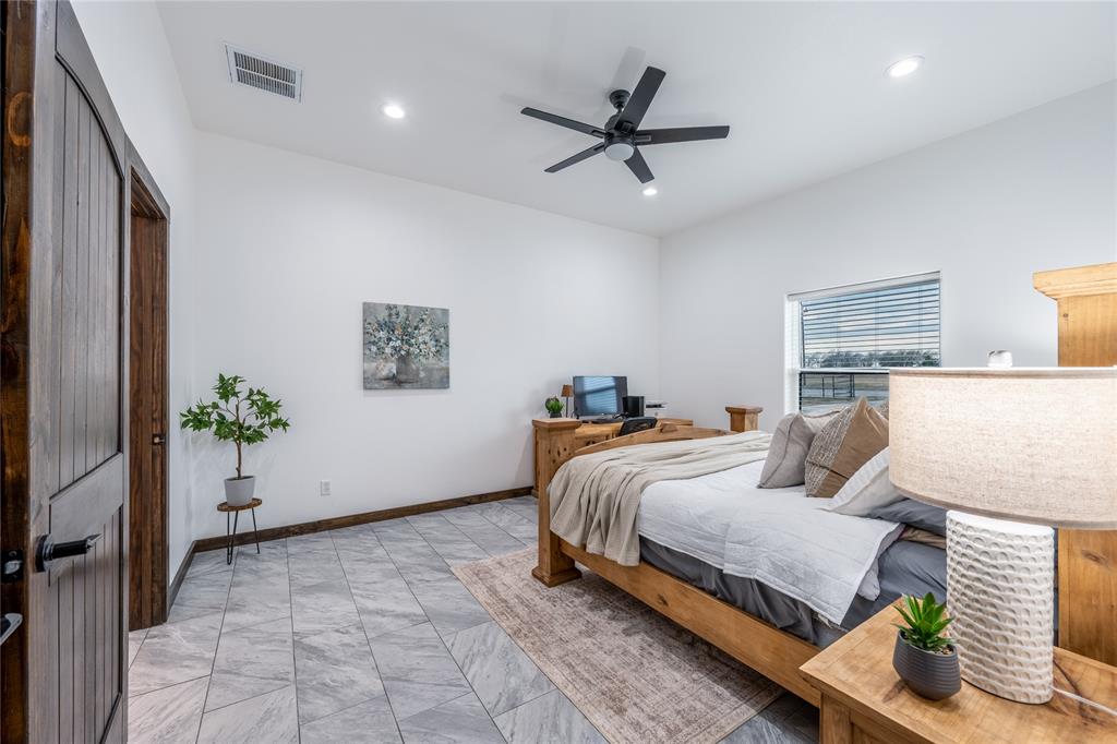 1706 County Road Sumner, TX 75486 - Photo 15 of 28 a bedroom with a bed and a potted plant