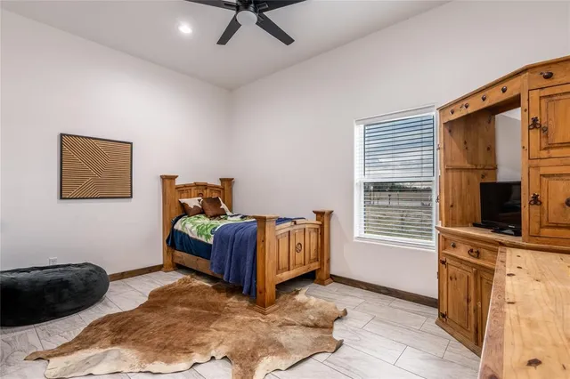 a bedroom with a bed window and a television
