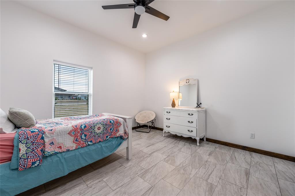 1706 County Road Sumner, TX 75486 - Photo 20 of 28 a bedroom with a bed and wooden floor