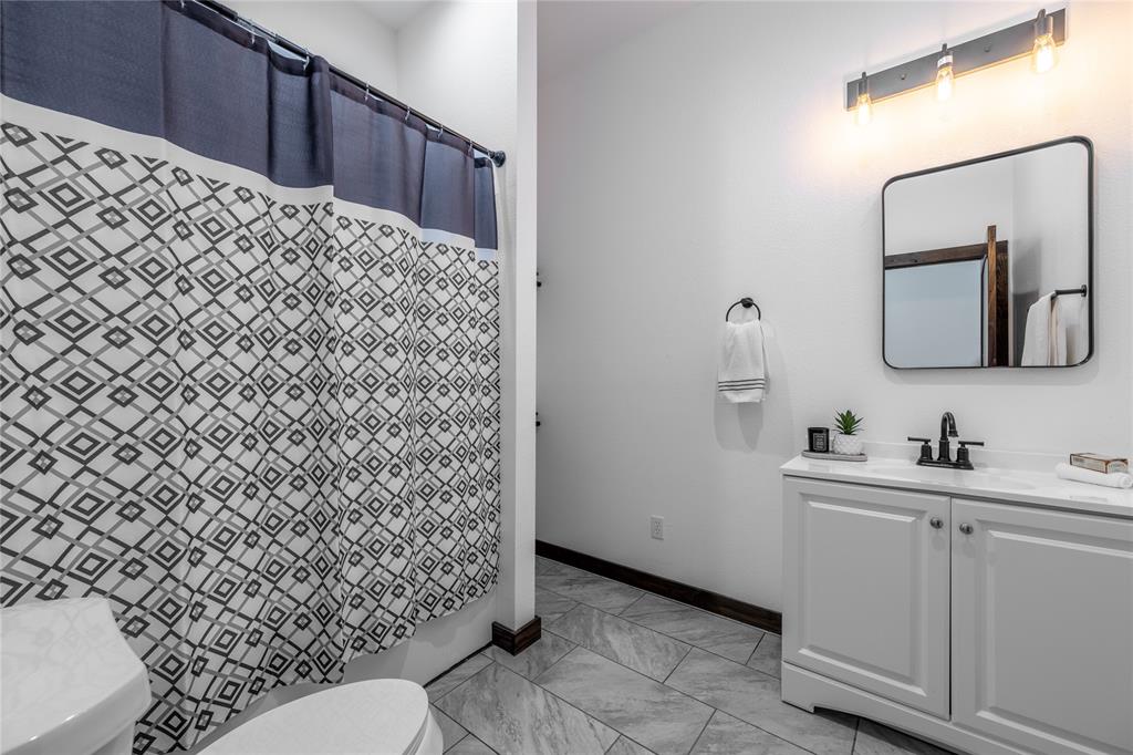 1706 County Road Sumner, TX 75486 - Photo 21 of 28 a bathroom with a toilet sink and mirror