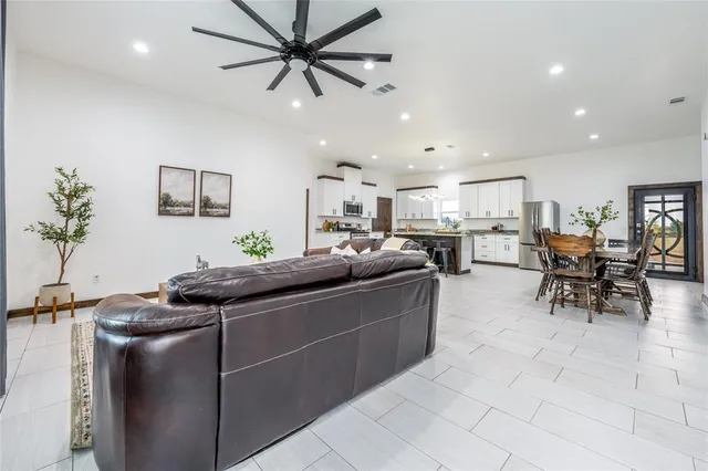 a living room with furniture and a potted plant