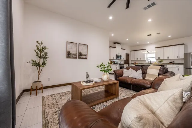 a living room with furniture and a potted plant