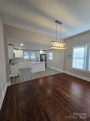 a view of kitchen and dining room with wooden floor