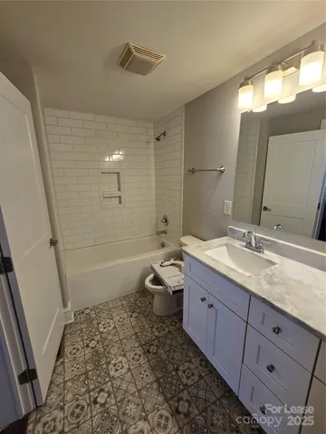 a bathroom with a double vanity sink toilet and shower
