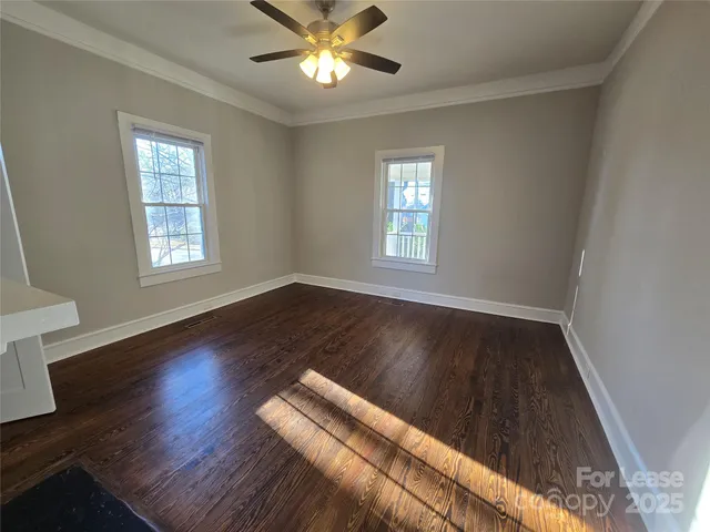 a view of wooden floor and windows in a room