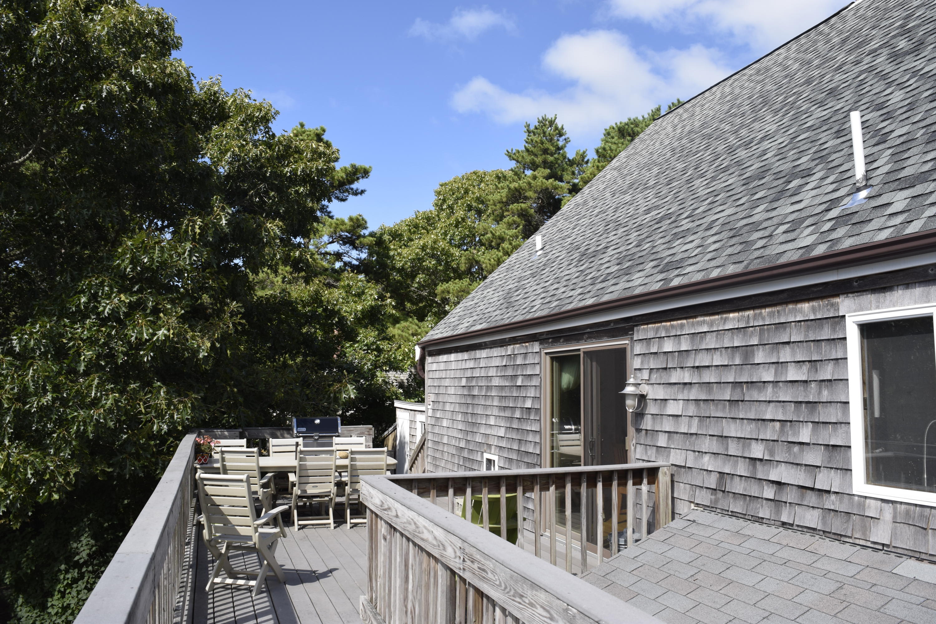 1069 Browns Neck Road Wellfleet, MA 02667 - Photo 8 of 34 a balcony of a house with wooden floor and outdoor seating