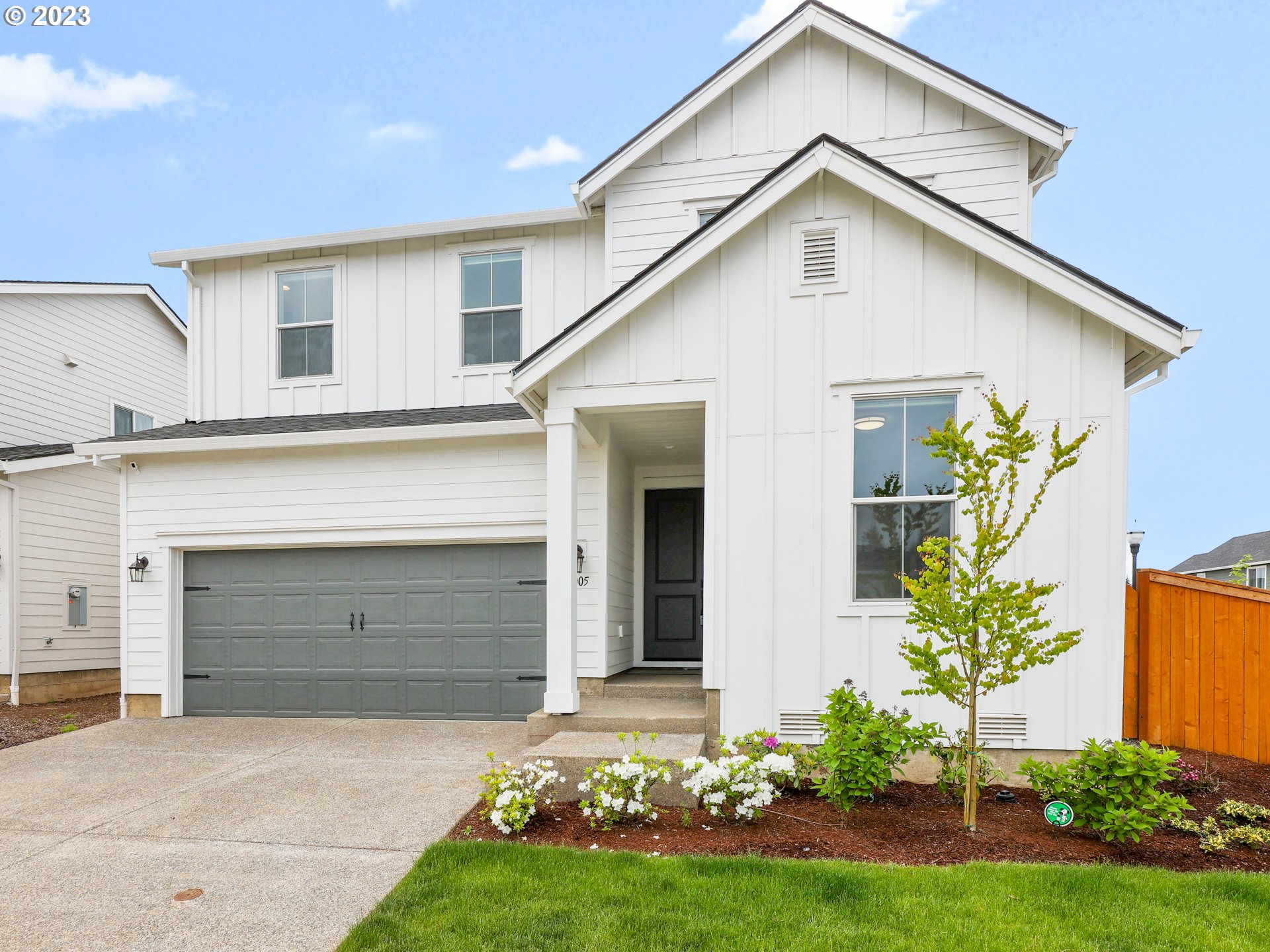 3005 North Mccanta Way Ridgefield, WA 98642 - Photo 1 of 37 a front view of a house with a garden