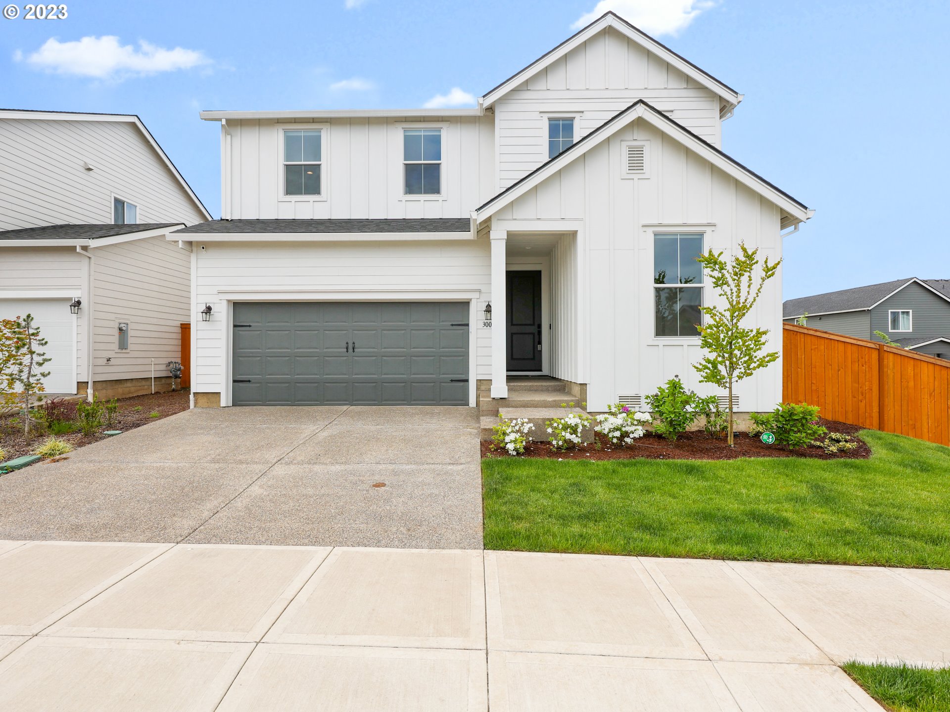 3005 North Mccanta Way Ridgefield, WA 98642 - Photo 2 of 37 a view of a white house with a small yard and a large parking space