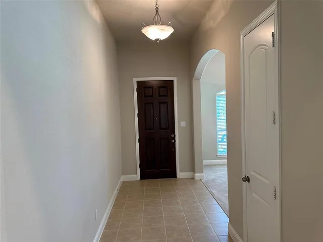 an empty room with closet and a chandelier fan