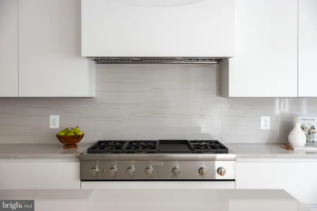 a stove top oven sitting inside of a kitchen