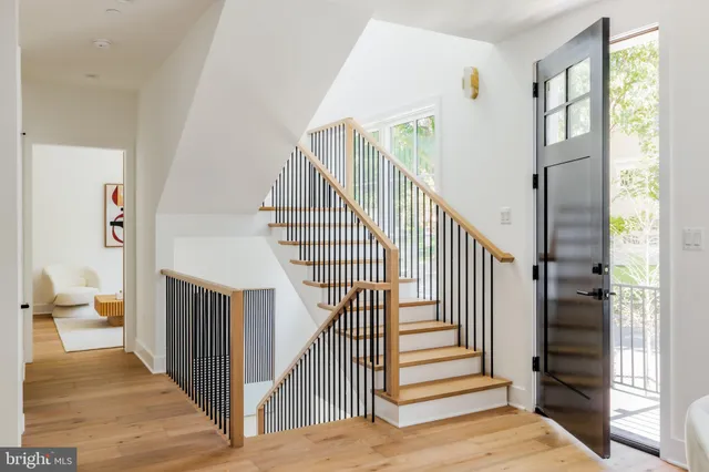 a view of entryway and hall with wooden floor