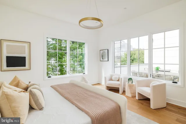 a spacious bedroom with a bed and a large window